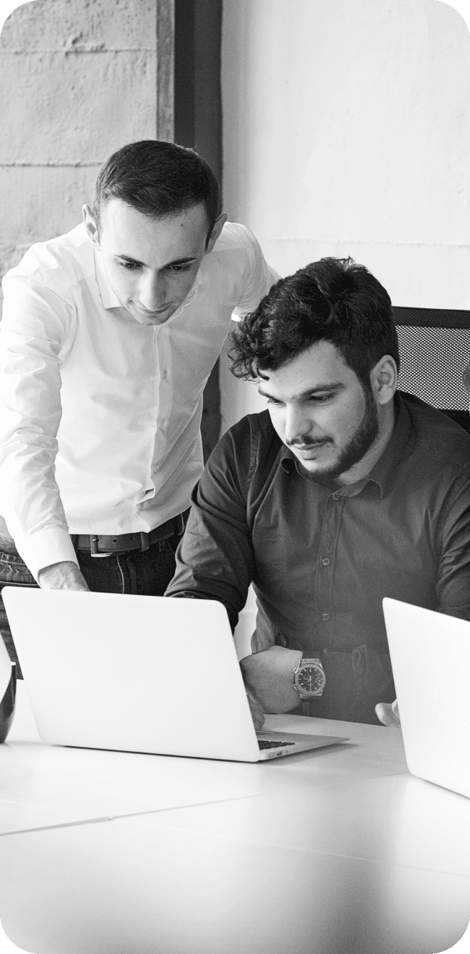 Two colleagues working together at a laptop